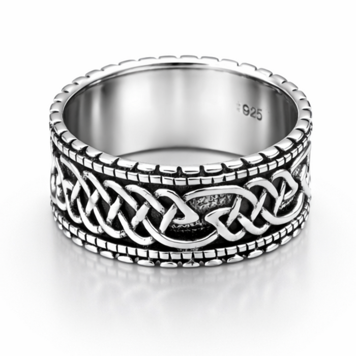 Sterling silver Celtic band ring with oxidised detail and beaded edge on a clean white background