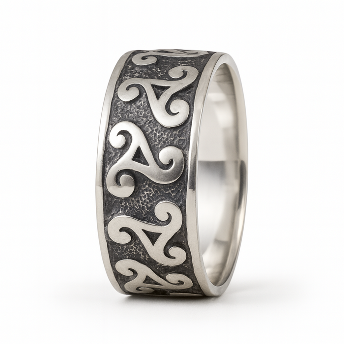Sterling silver triskele ring with oxidised Celtic spiral design on a clean white background