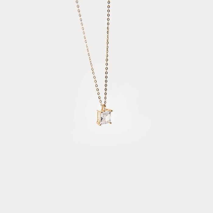 The One Necklace by LLUME Jewelry is a gold vermeil piece with a square-cut clear gemstone pendant, shown against a plain white background.