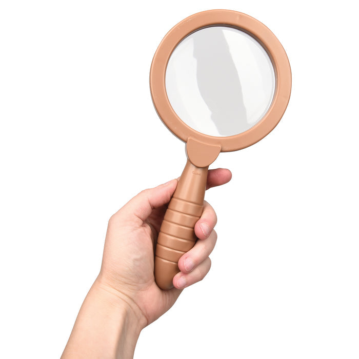 Hand holding a beige magnifying glass against a white background