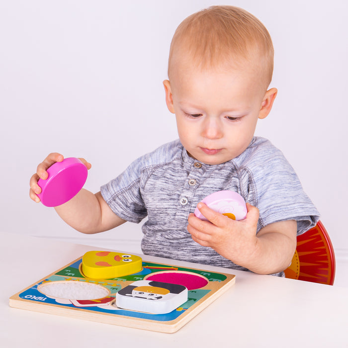 Child playing with colorful puzzle pieces on a white background