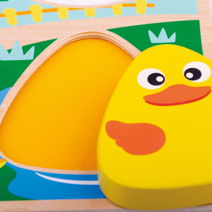Yellow rubber duck toy with a wooden base featuring a colorful scene.