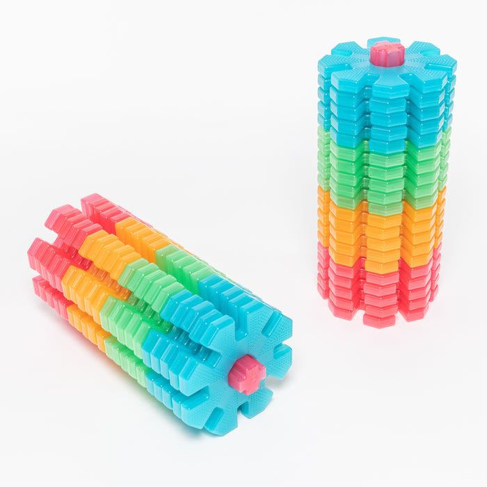 Stackable building blocks in rainbow colors on a white background