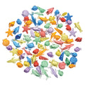 Assorted colorful miniature ocean-themed figurines on a white background