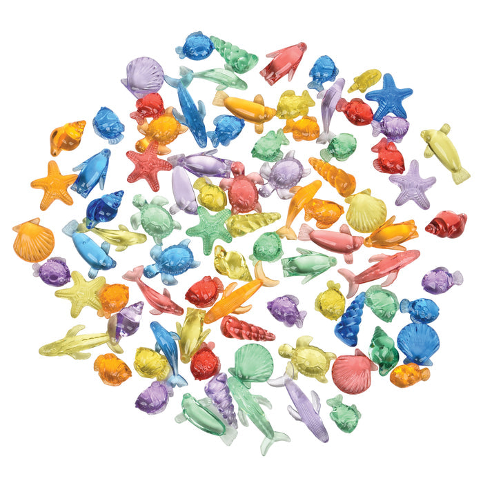 Assorted colorful miniature ocean-themed figurines on a white background