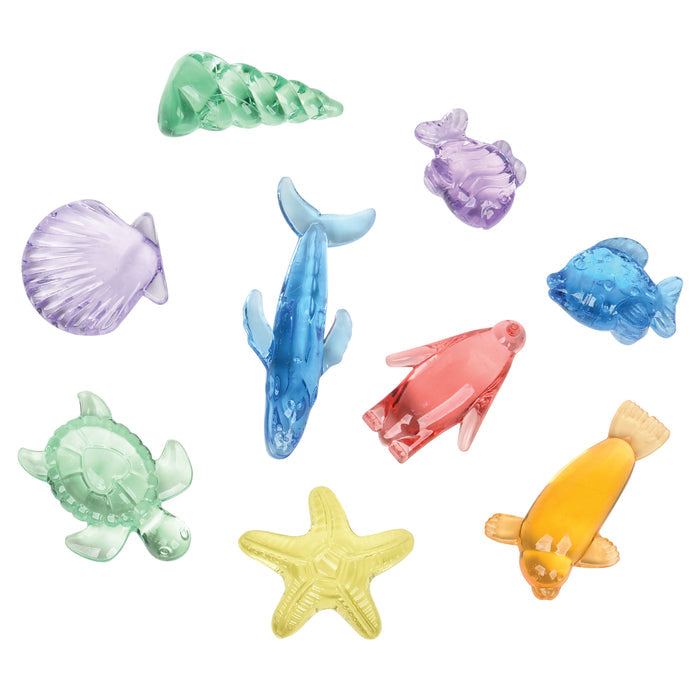Colorful sea-themed figurines including shells, dolphins, and turtles on a white background.