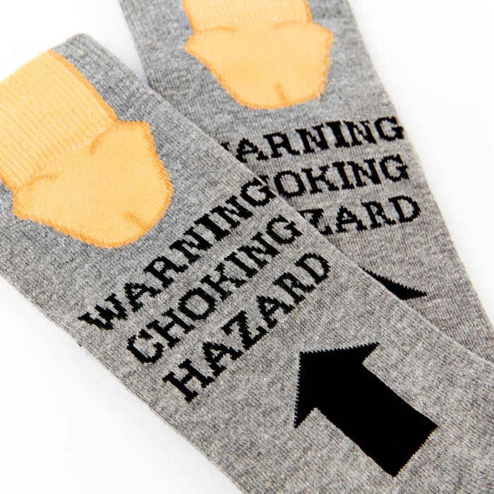 close up of Warning Choking Hazard socks showing text and arrow detail