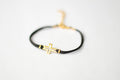 Women's bracelet with gold tone outline cross charm, black cord - shani-adi-jewerly